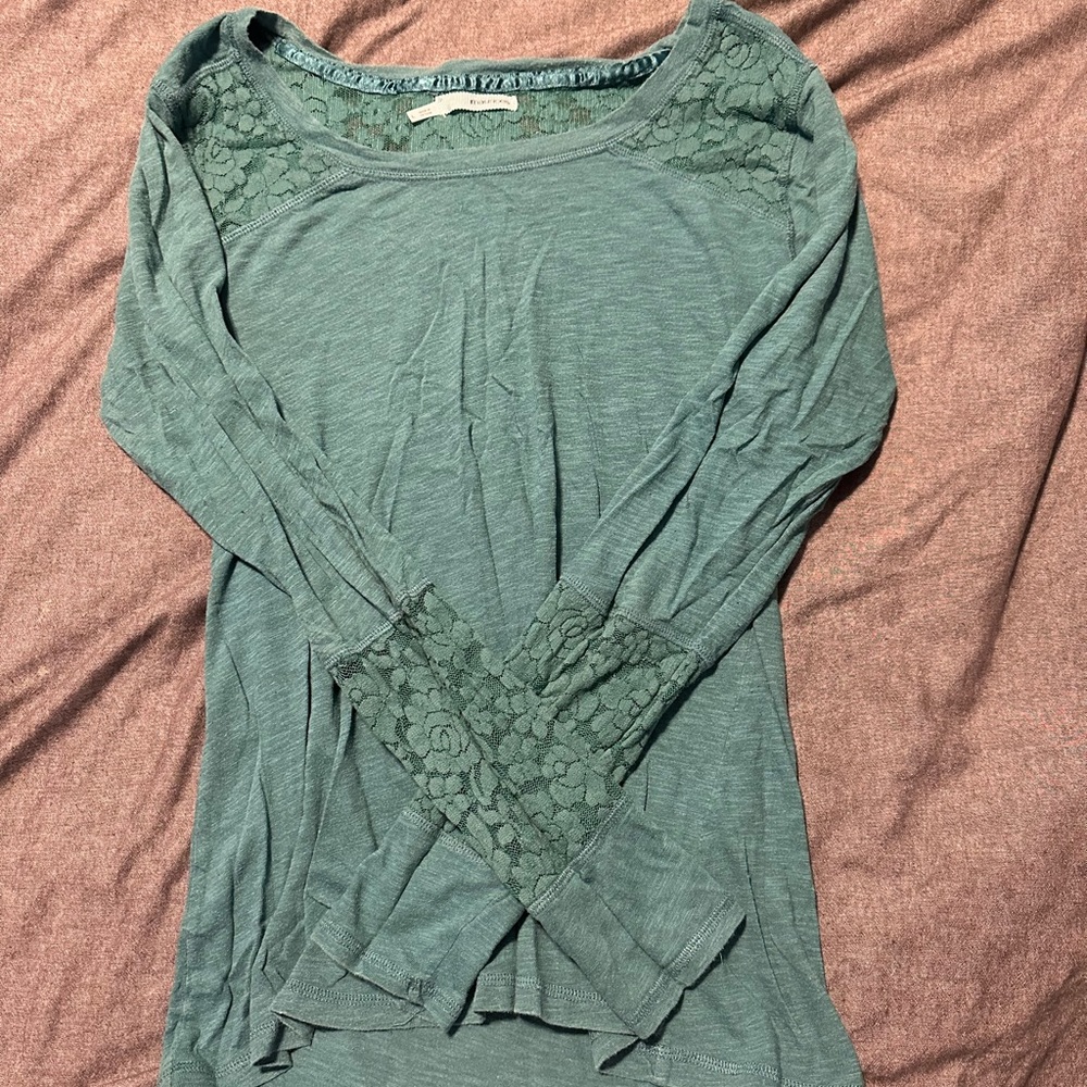 Long sleeve shirt with lace cut outs.